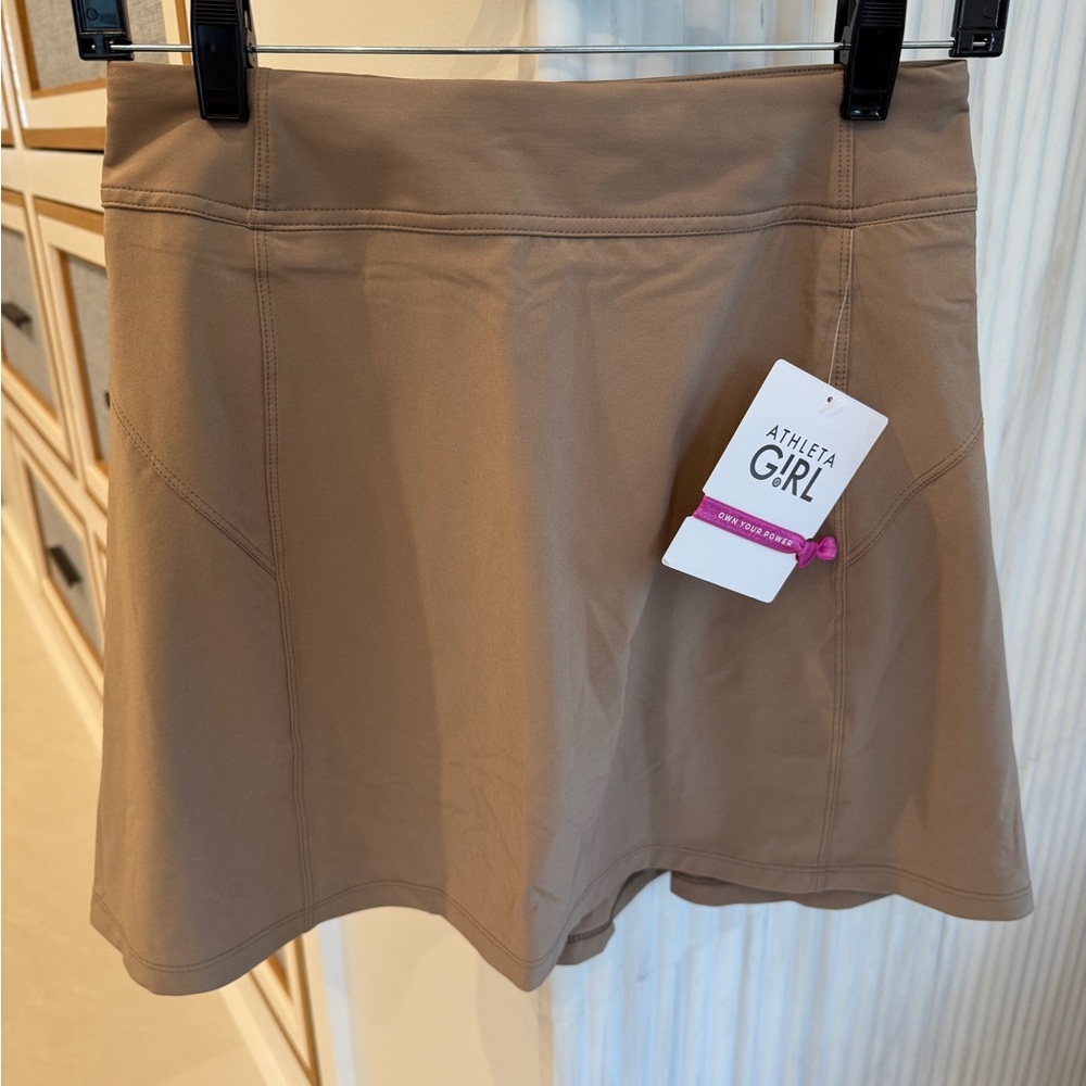 Two Athleta Girl Skorts - one light Beige and one darker beige. Price for both.